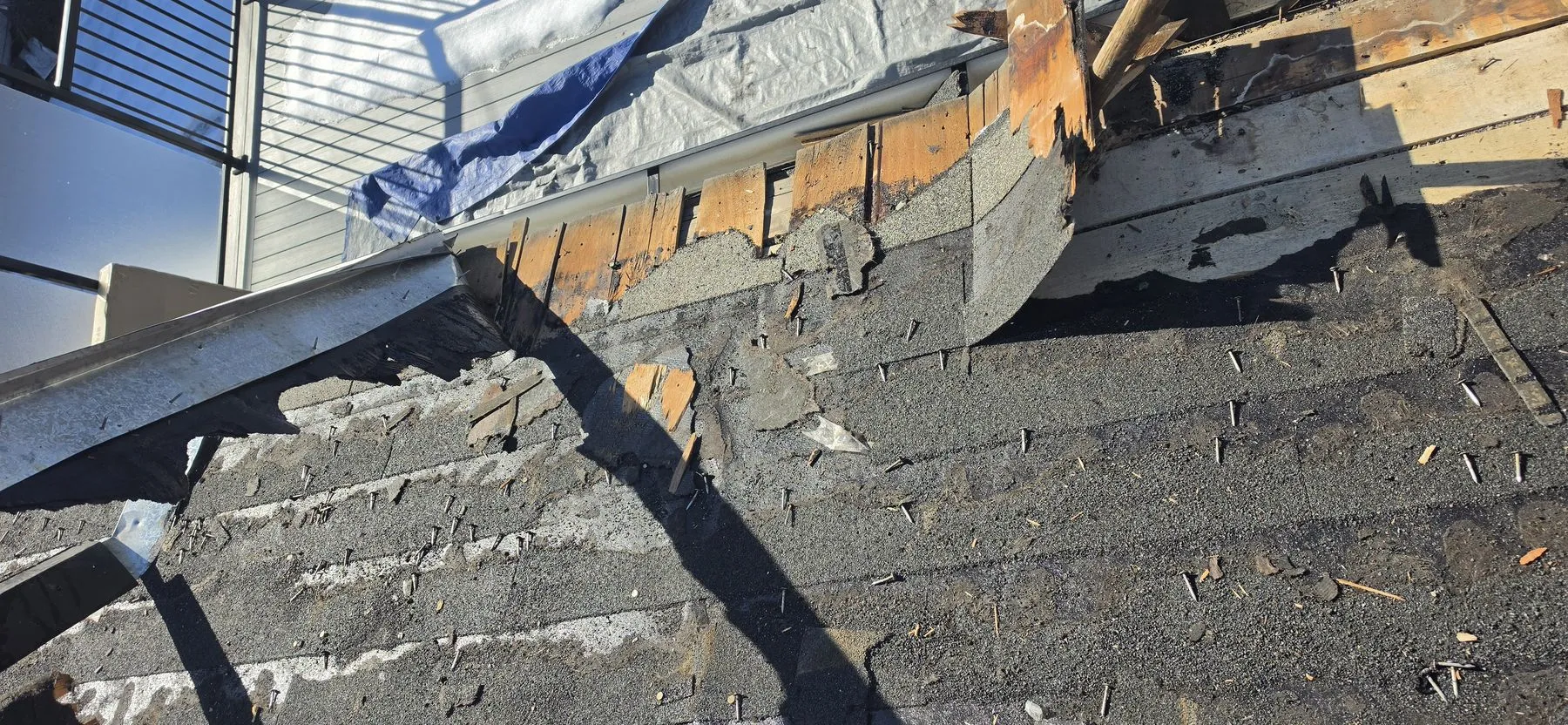 Old roof being removed during a Spruce Cliff Calgary replacement