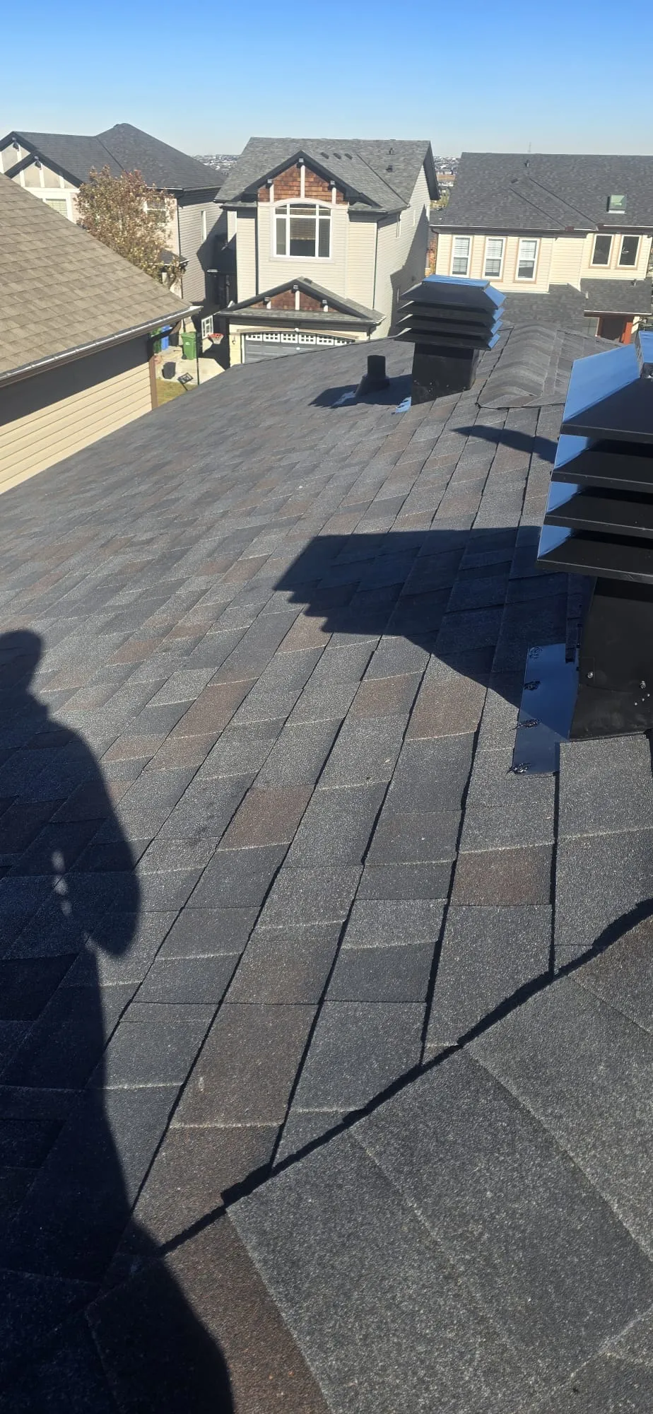Attic louvered exhaust vents shingle roof in Calgary