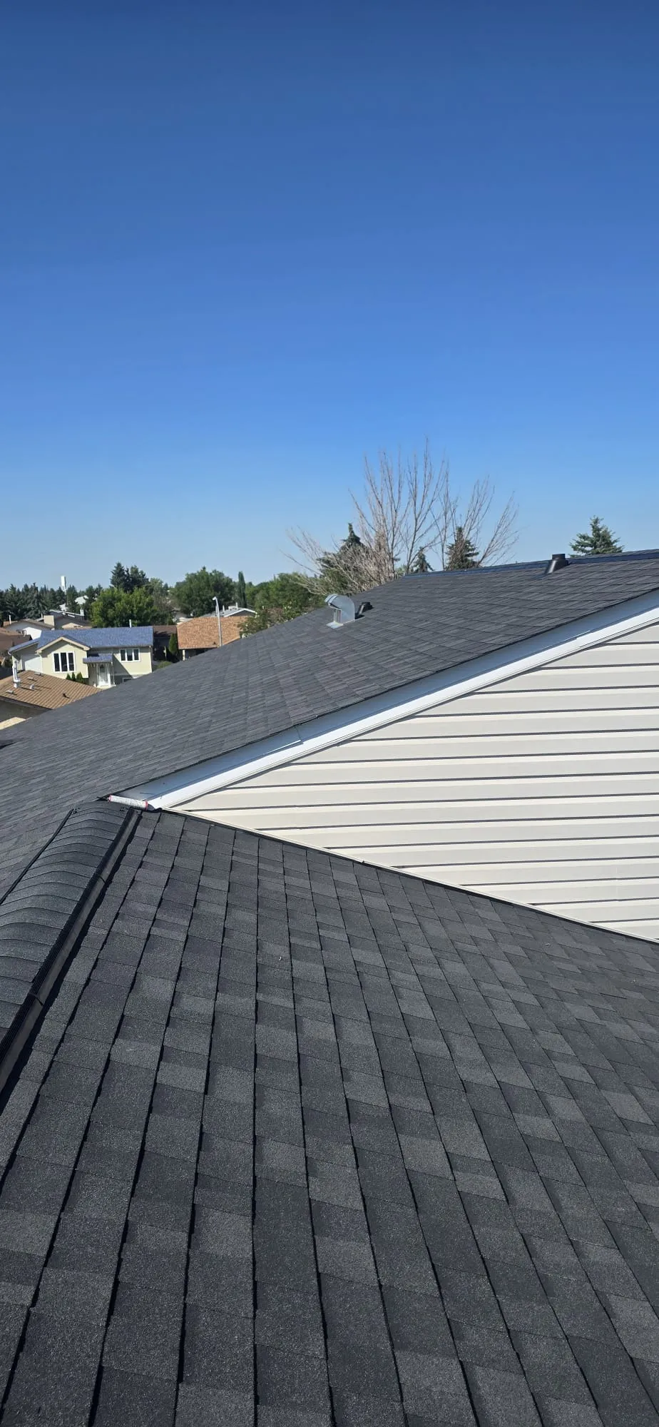 Attic ridge vent charcoal shingle roof in Calgary