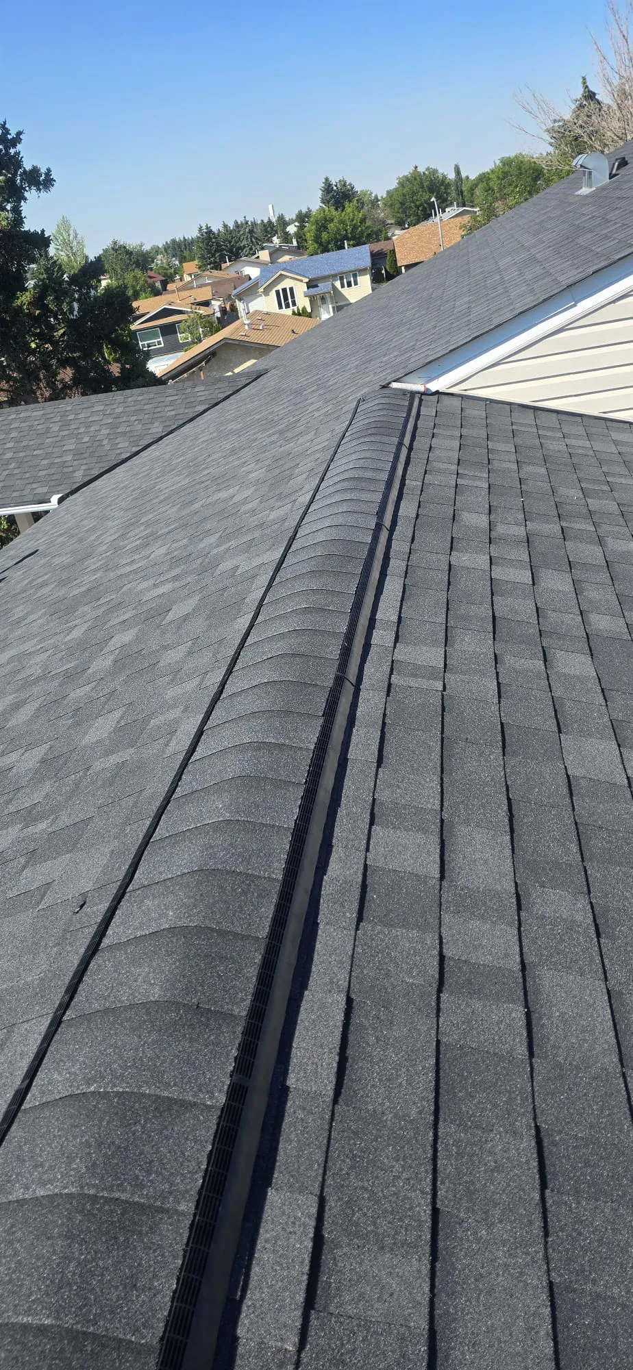 Attic ridge vent shingle roof in Calgary