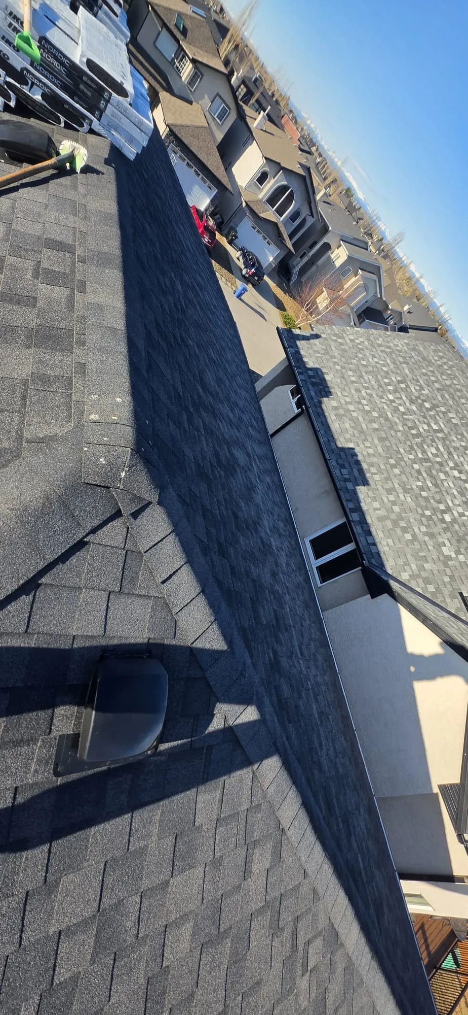 Black shingle roof valley aerial in Calgary