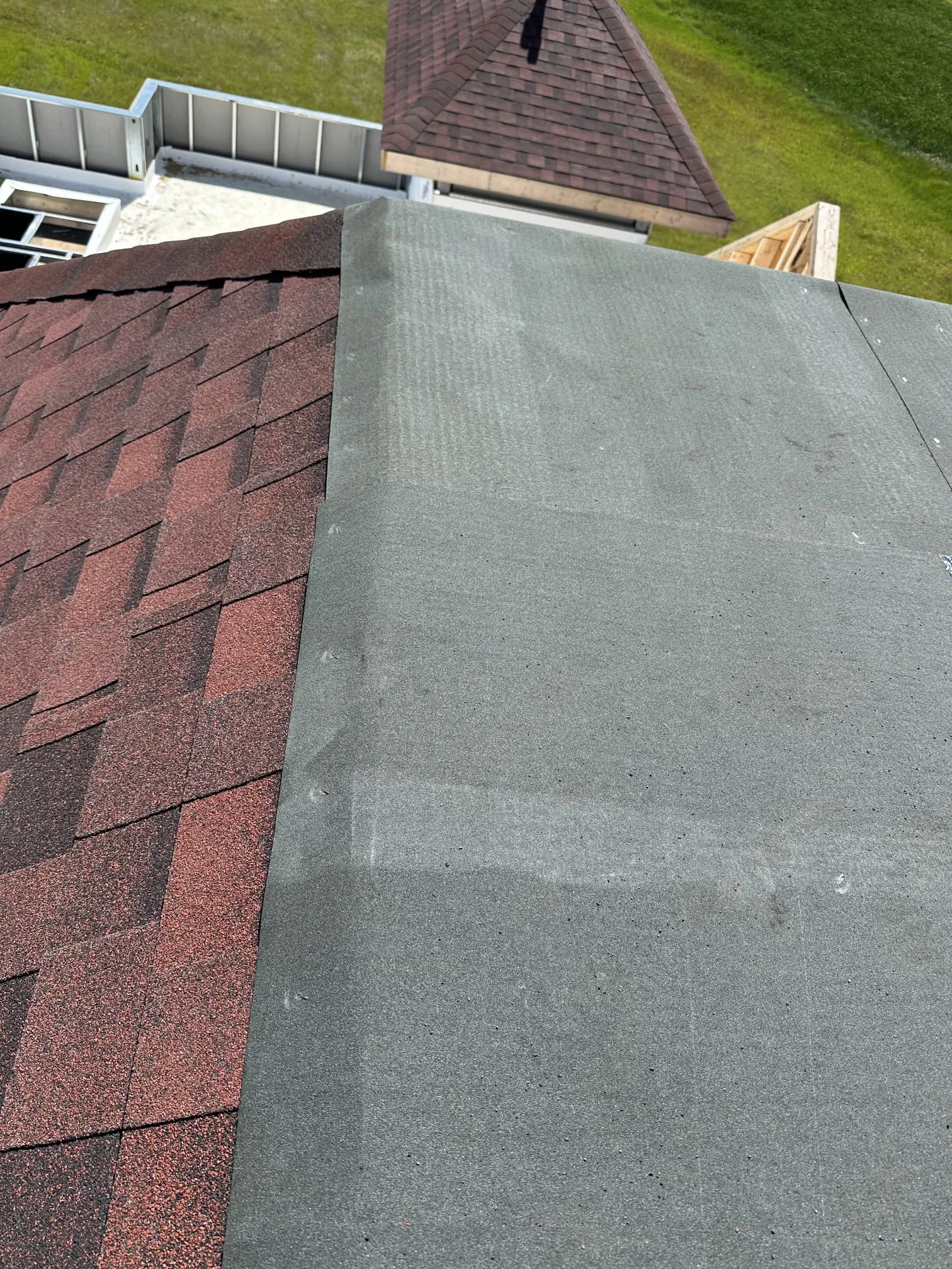 Flat roof membrane adjacent shingle roof