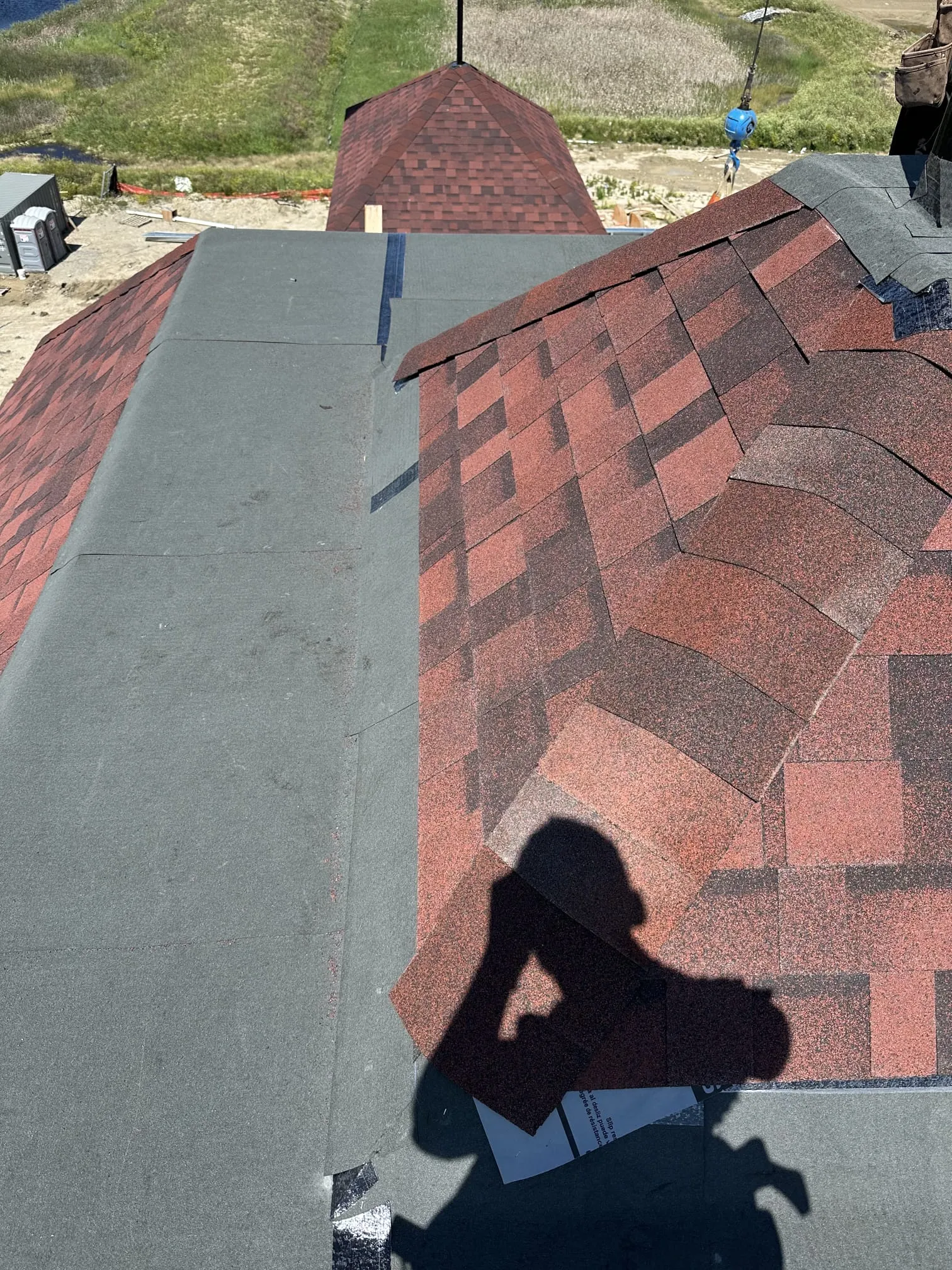 Flat roof membrane red shingle turret roof