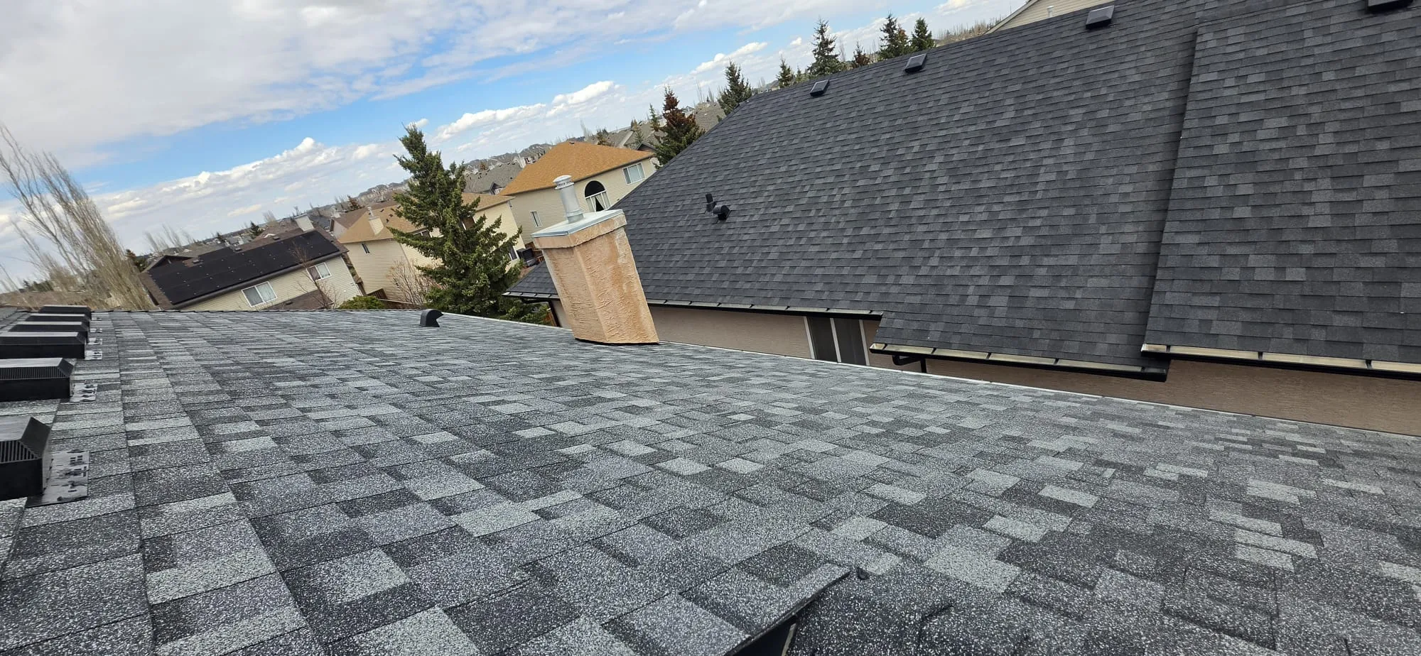 Grey shingle roof with chimney in Calgary