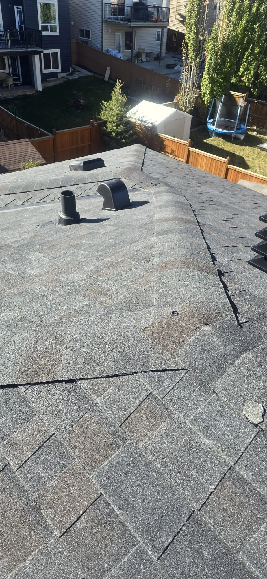 Hail damaged shingles roof vents inspection in Calgary