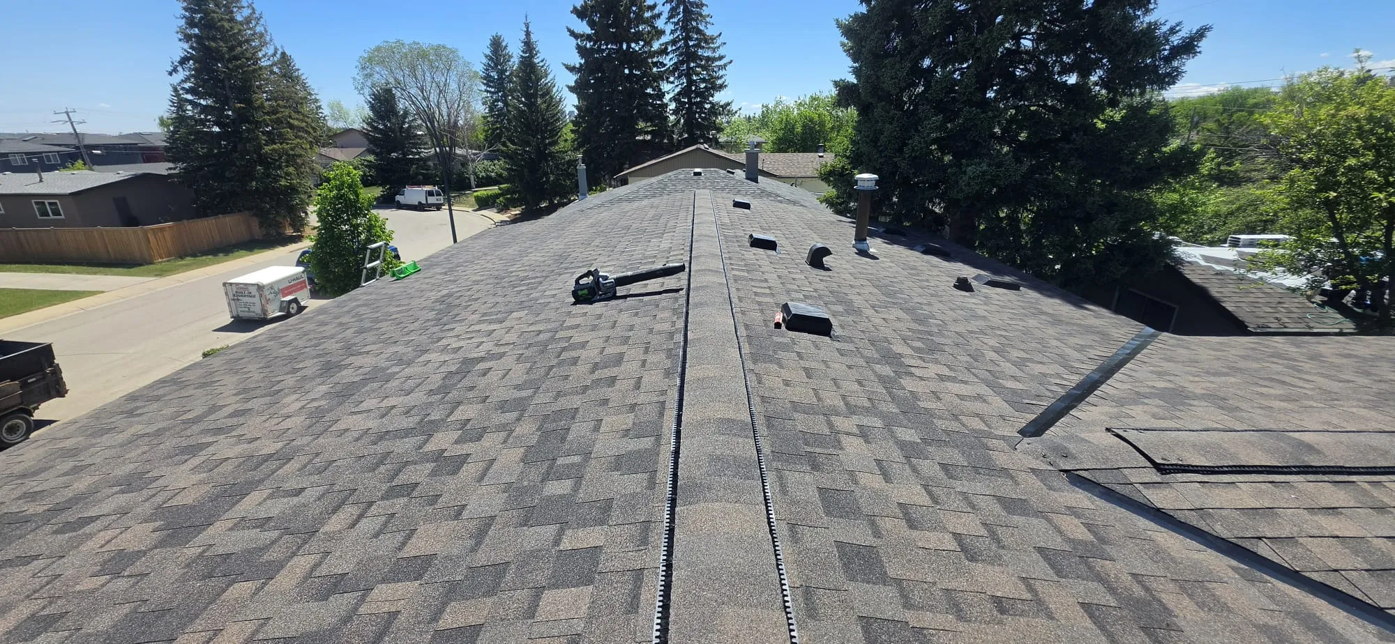 New asphalt shingle roof ridge vent in Calgary