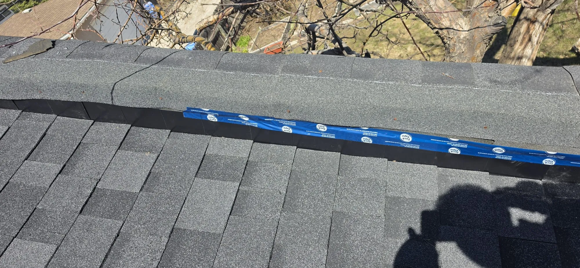 Ridge cap shingle inspection tuck tape